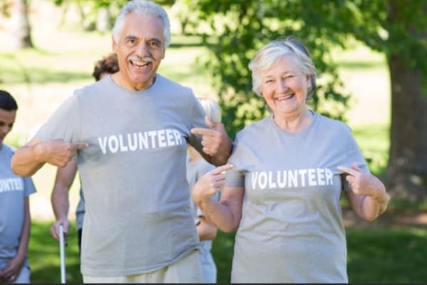Image of older man and woman with shirts that say volunteer